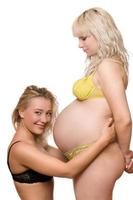 young woman and a pregnant girlfriend photo