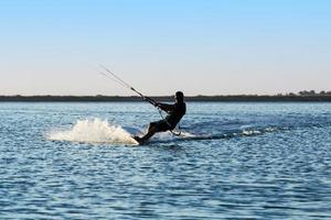 Silhouette of a kitesurfer photo