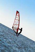 Silhouette of a windsurfer on the sea photo