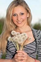 attractive blonde with a dandelions photo