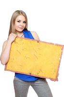 Lovely young woman posing with yellow vintage board photo