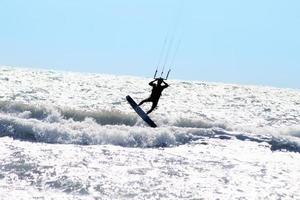 Silhouette of kite surfer photo