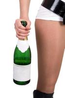 Young woman with a champagne bottle. Isolated photo
