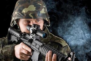 Soldier with the smoking gun. Closeup photo