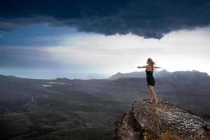 Young woman on the edge of a cliff photo