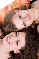 Portrait of the two beauty young women laying on a pillow 3 photo