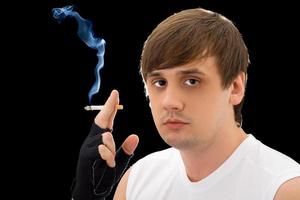 Portrait of the young man with a cigarette. Isolated photo