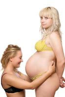 young woman and a pregnant girlfriend photo