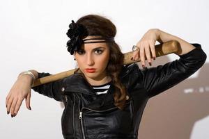 Serious young woman with a bat photo