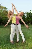 Two happy attractive blonde in white jeans photo