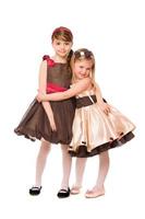 Two cute little girls in a dress. Isolated photo