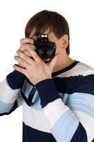 Young man with a camera. Isolated on white photo