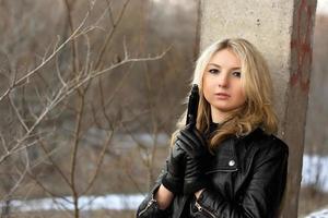 Sensual young woman holding a weapon photo