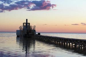 Ferryboat near the pier at sunset photo