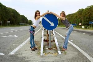 Two girls stand on a road photo