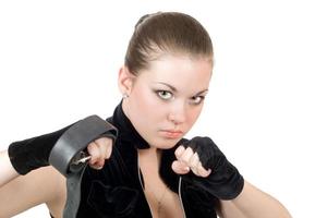 Pretty young angry woman throwing a punch photo