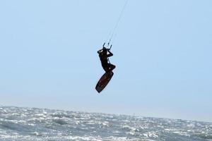 Silhouette of kite surfer photo