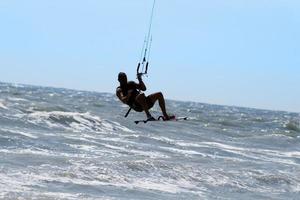 Silhouette of kite surfer photo