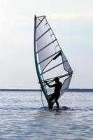 Silhouette of a windsurfer photo