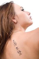 Tattoo on a back of the young woman. Isolated 4 photo