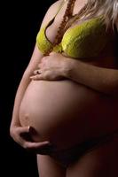 Belly of a young pregnant woman. Isolated photo