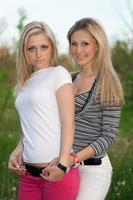 Portrait of two smiling attractive young women photo