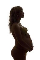 Silhouette of a pregnant girl. Isolated photo
