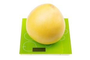 Pomelo fruit on square scales photo
