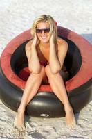 Happy girl sitting in an inflatable chair photo