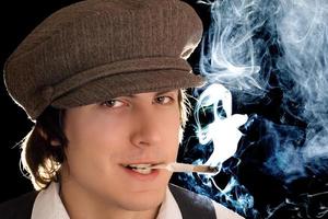 Young man smoking a cigarette in vintage clothes photo