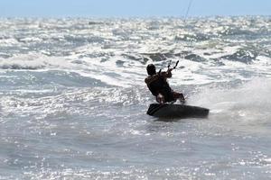 Silhouette of kite surfer photo