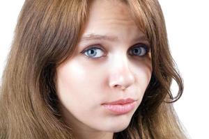 Portrait of the offended beauty young woman. Isolated on white photo