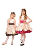 Two cute little girls in a dress photo