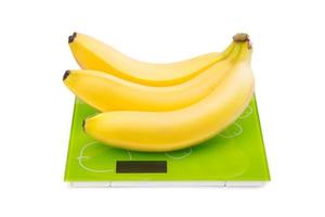 Three yellow bananas on scales photo