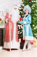 Snow maiden and santa claus photo