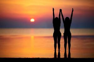 Silhouettes of two women photo