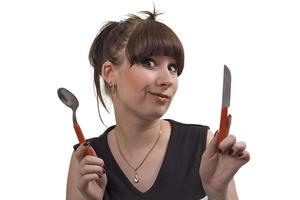 The mad housewife with knife and spoon. funny picture photo