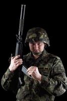 Soldier reloading magazine of m16 photo