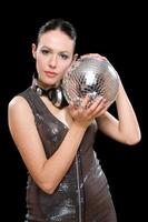 Portrait of beautiful young brunette with a mirror ball photo