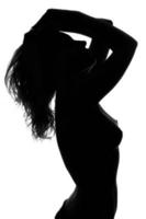 Silhouette of a sexy naked young woman photo