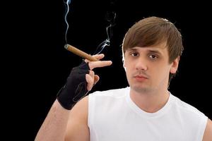 Portrait of the young man with cigar. Isolated