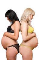 Two pregnant young women. Isolated photo