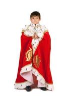 Boy dressed in a robe of King. Isolated photo