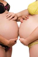 Two bellies of pregnant young women photo