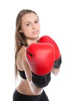Young blonde demonstrating boxing gloves. photo