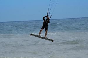 Silhouette of kite surfer photo