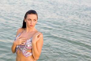 sexy wet young woman in the water photo