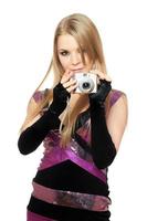 Young pretty blonde holding a photo camera. Isolated