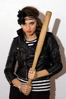 Pretty young woman with a bat photo