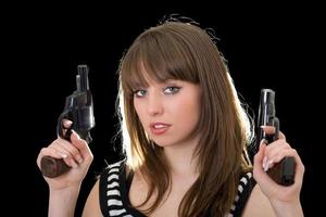 Attractive young woman with two pistol. Isolated photo